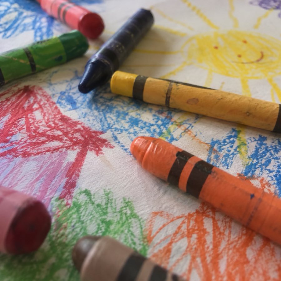 Crayons scattered over a drawing, close and a little blurred